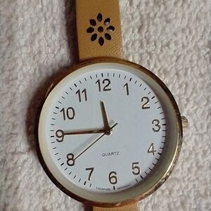 Women's goldtone tan floral band watch works has battery